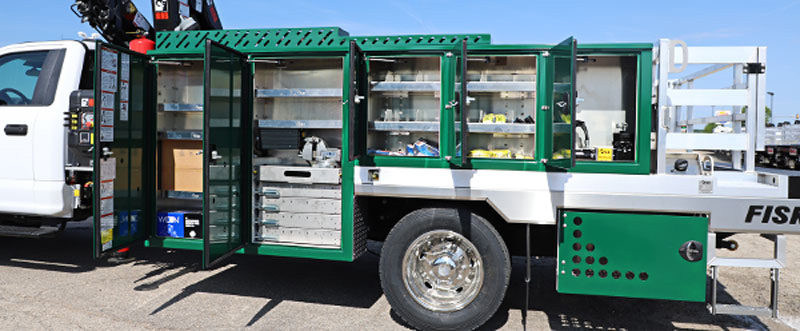 green service truck with multiple storage compartments