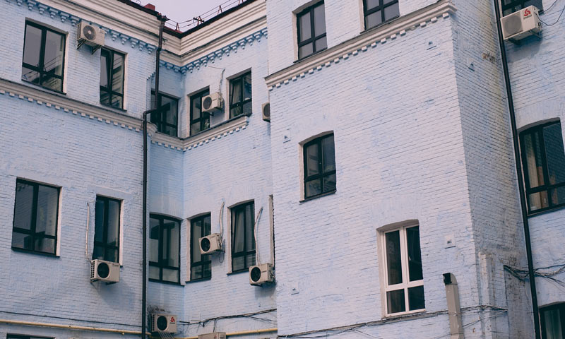 old house exterior with A/Cs on the walls