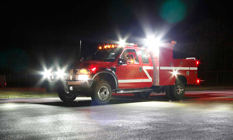 red service truck with spotlights and floodlights