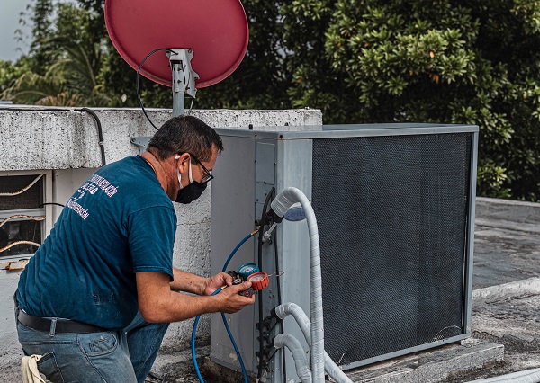 service tech checking an air conditioner