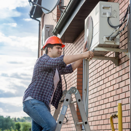 HVAC technician inspecting an air conditioning unit