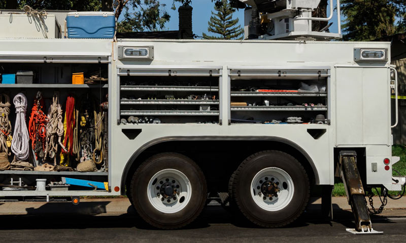 white service truck with multiple storage areas