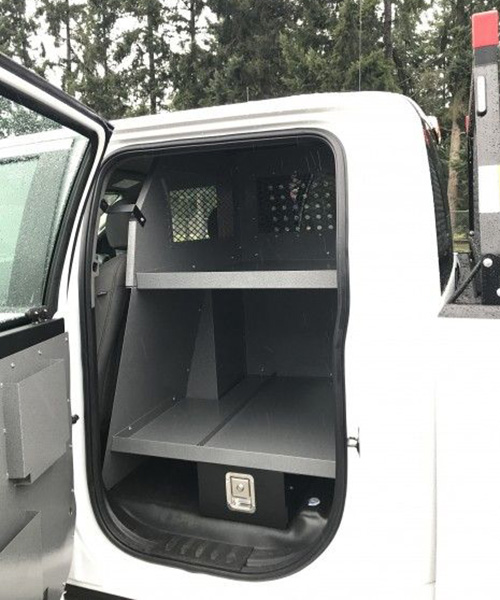 white service truck with open cab cabinets